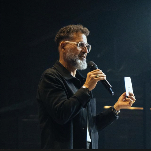 Pastor George Georgiou speaking on stage